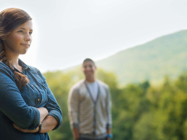 A man and woman standing in evening light outdoors