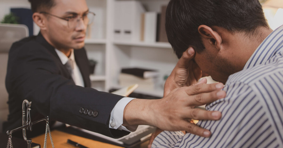Injury lawyer comforting a client