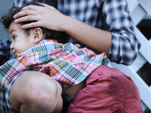 Mother holding her kid on her arms
