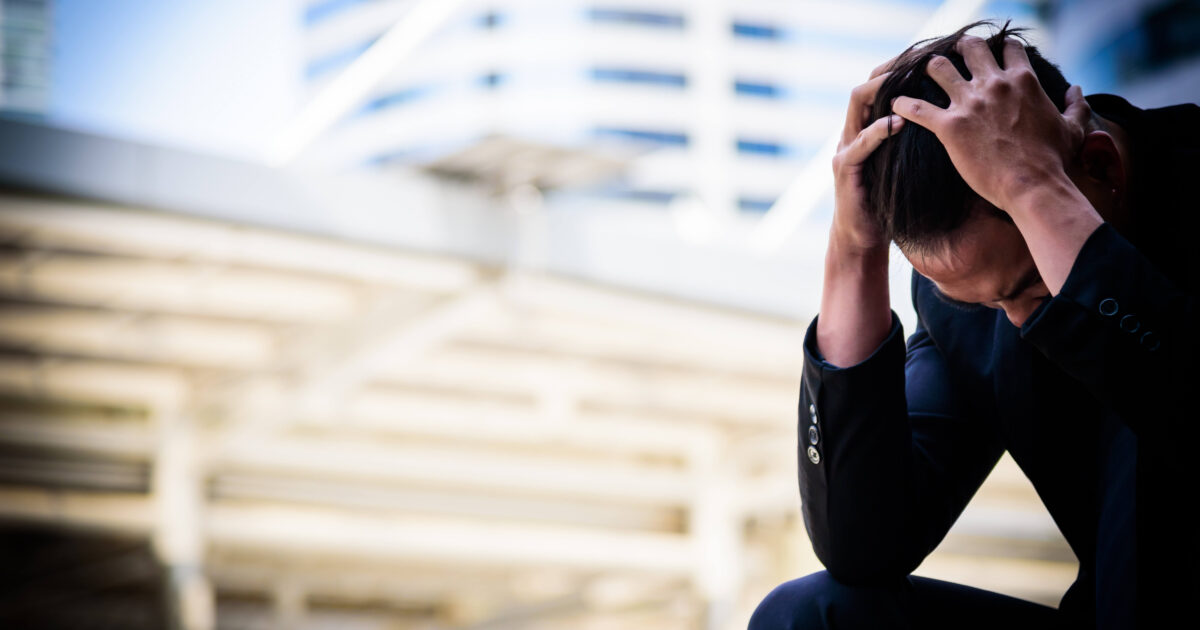 Asian businessman feel sad and frustrated upset