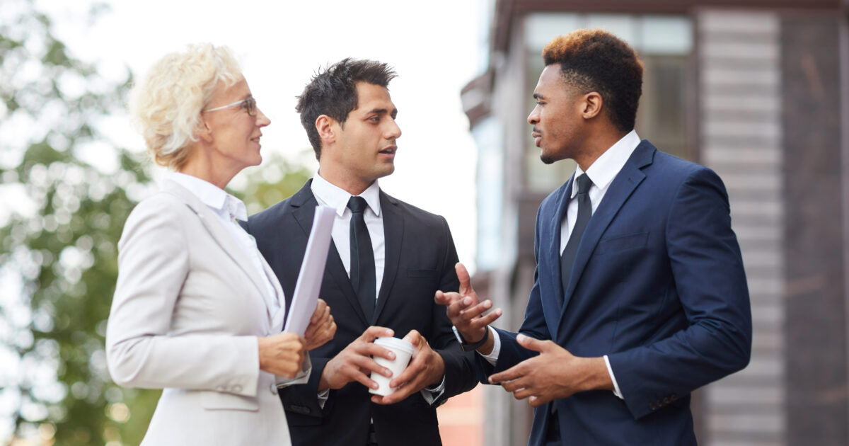 Confident African businessman explaining his opinion to colleagues