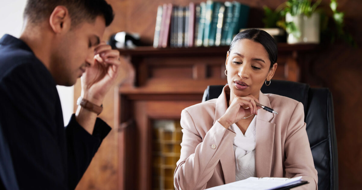 Concerned client talking to his lawyer to discuss false domestic violence accusations.