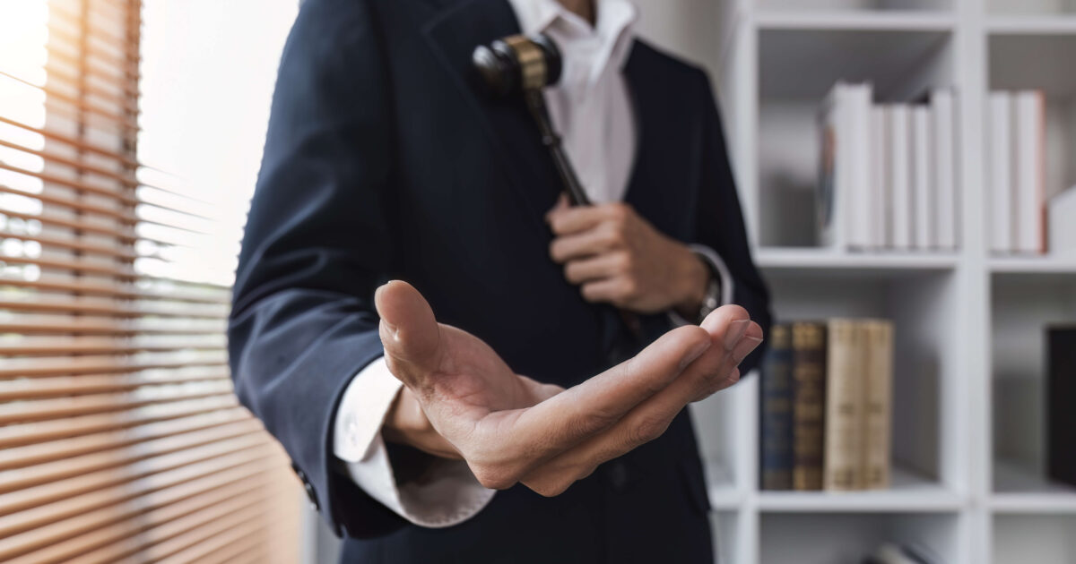 Lawyer showing a hand as a friendly gesture for client