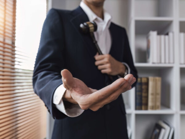Lawyer showing a hand as a friendly gesture for client