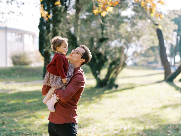dad holds a little girl in his arms