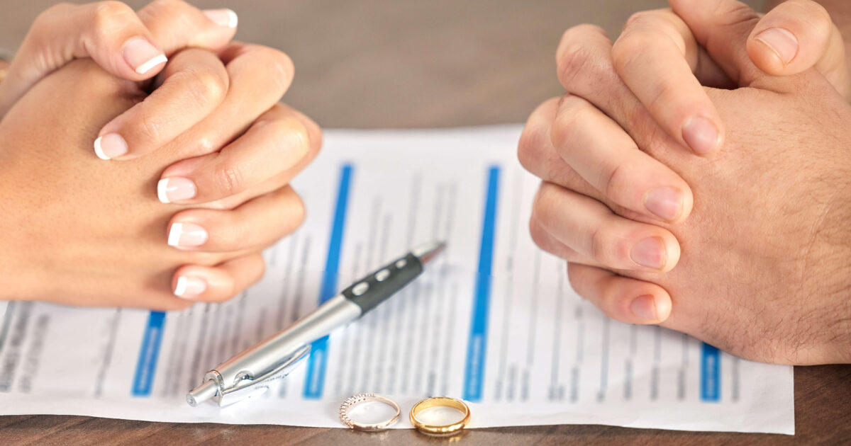 Couple signing a postnuptial agreement