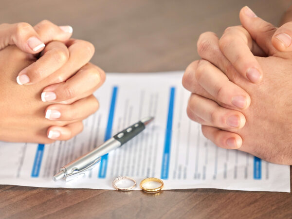 Couple signing a postnuptial agreement