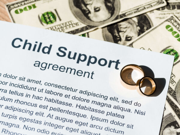 Document with child support agreement near dollar sign