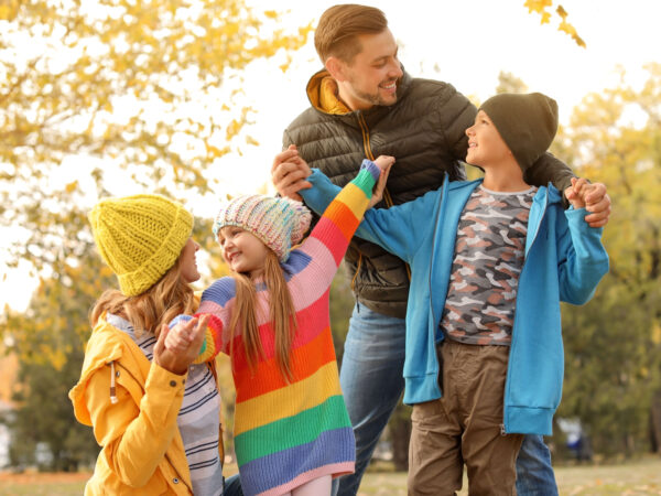 Happy family with children together in park autum