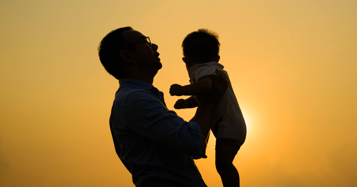 Father holding kid in the air