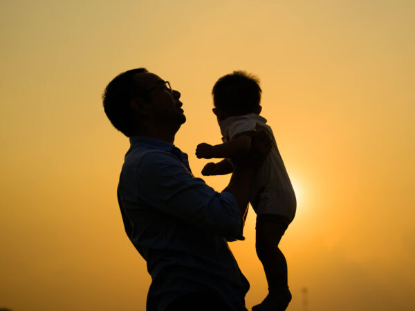Father holding kid in the air