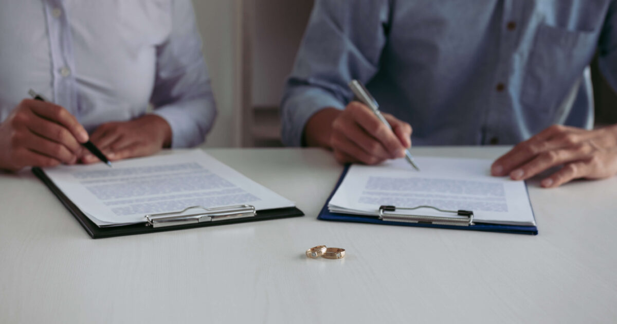 People signing divorce papers