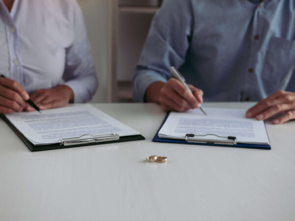 Couple signing divorce papers