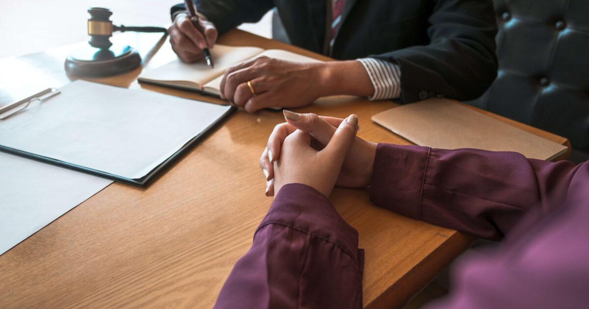 Lawyer working on a desk with client