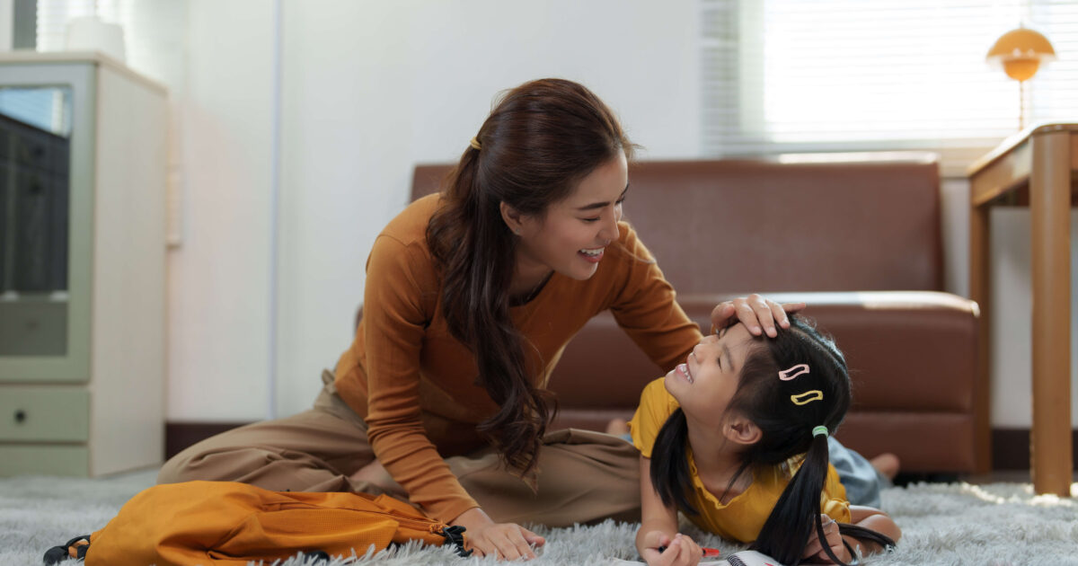 Loving mother supporting daughter with homework