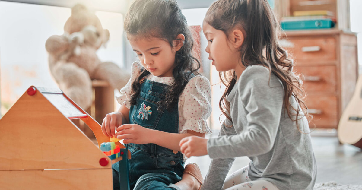 Two girls playing with their toys