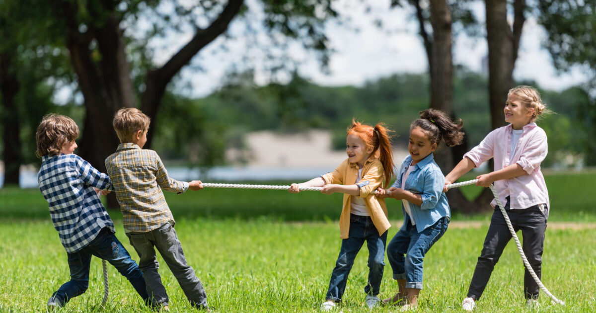 Side view of-beautiful little multiethnic kids playing