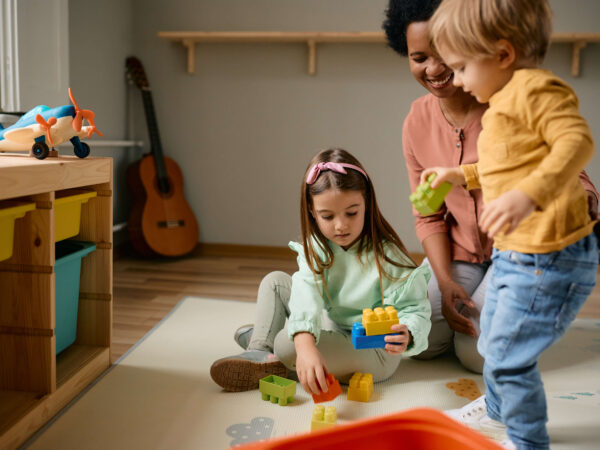 Small kids and their-african american nanny playing