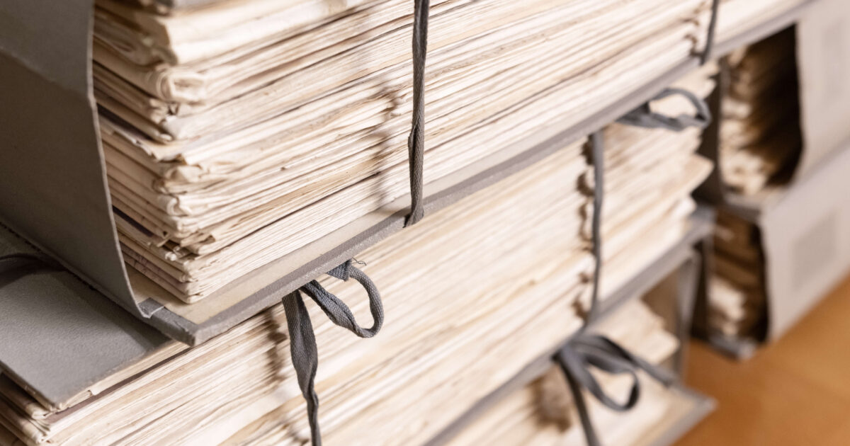 Stacks of old working paper documents