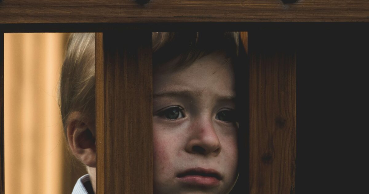 Kid-looking-outside-with-a-face-of-discomfort