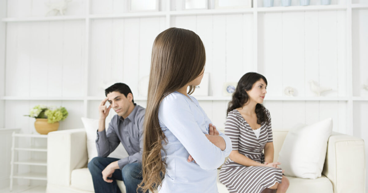 Girl looking at her hostile parents