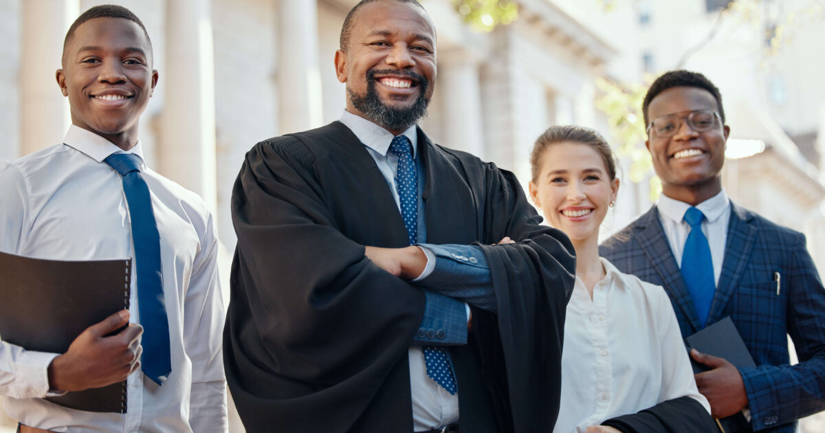 Team of lawyer in suits smiling