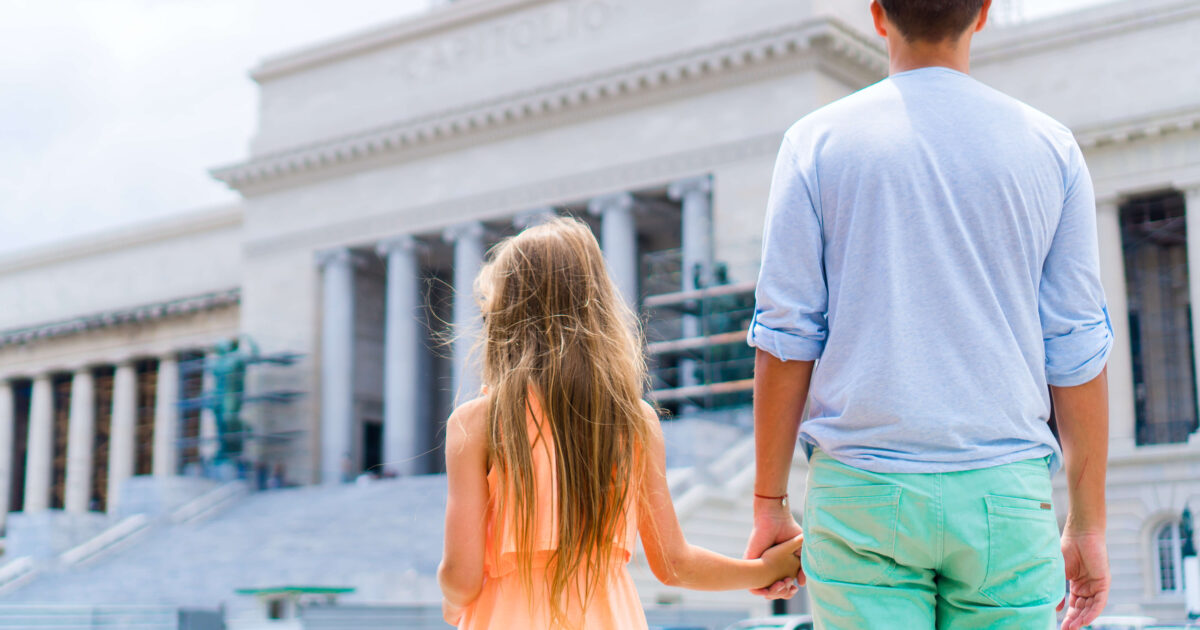 Girl with dad going to a court