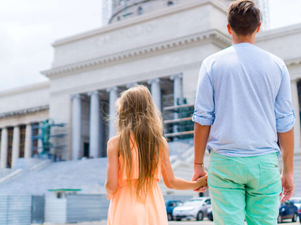 Girl with dad going to a court