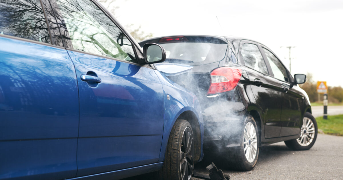 Two Damaged Cars Involved In Road Traffic Accident Showing Smoke After Collision