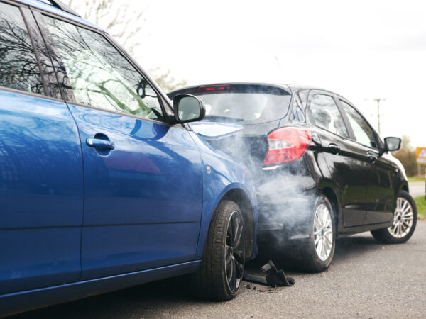 Two Damaged Cars Involved In Road Traffic Accident Showing Smoke After Collision