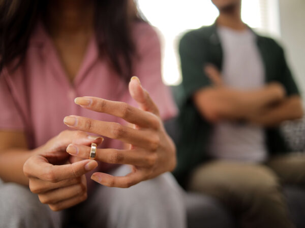 woman's hand removes wedding ring after legal separation