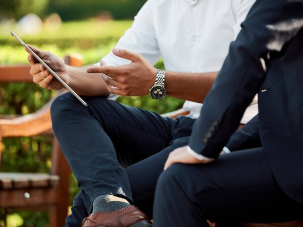 Two people seating on a bench discussing legal options