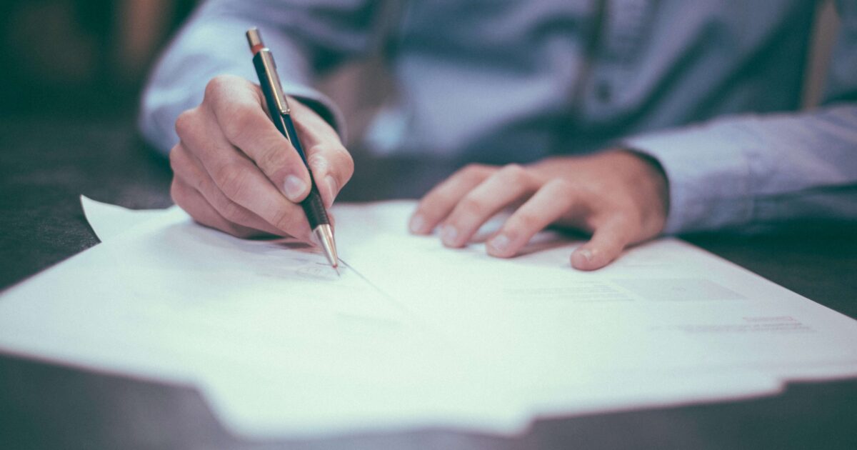 Lawyer writing a retainer for a client
