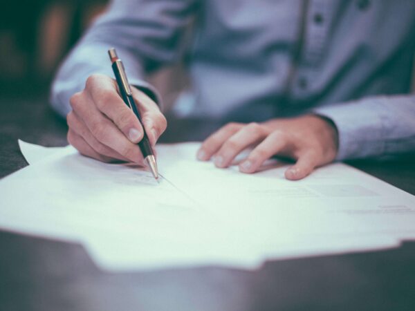 Lawyer writing a retainer for a client