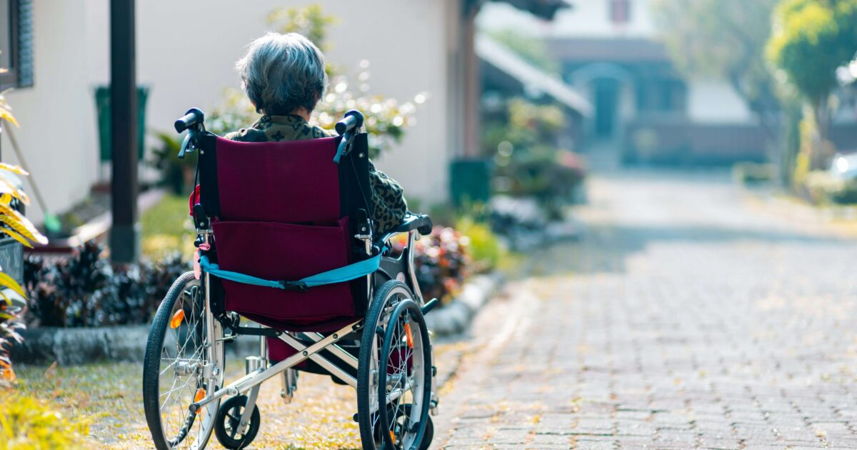Old women in a wheelchair looking at the horizon