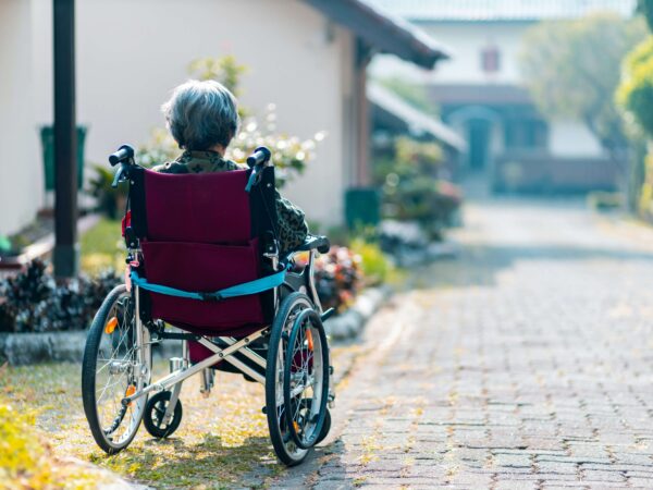 Old women in a wheelchair looking at the horizon